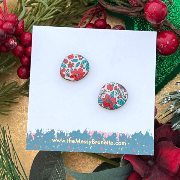 Floral patterned earrings on a branded card with decorative background