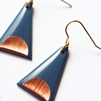 Blue and copper triangle-shaped earrings on a white background with 'dana' branding.