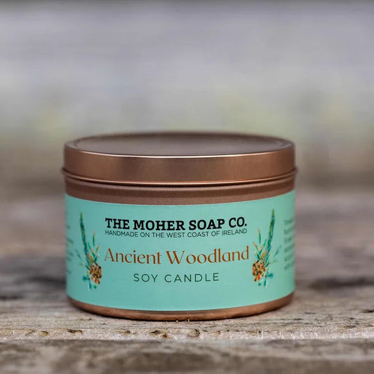Candle jar with 'The Moher Soap Co.' label on a wooden surface