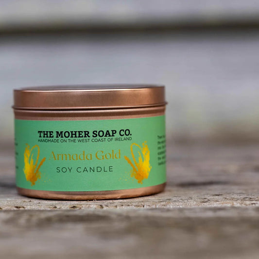 Candle in a tin from The Moher Soap Co. on a wooden surface