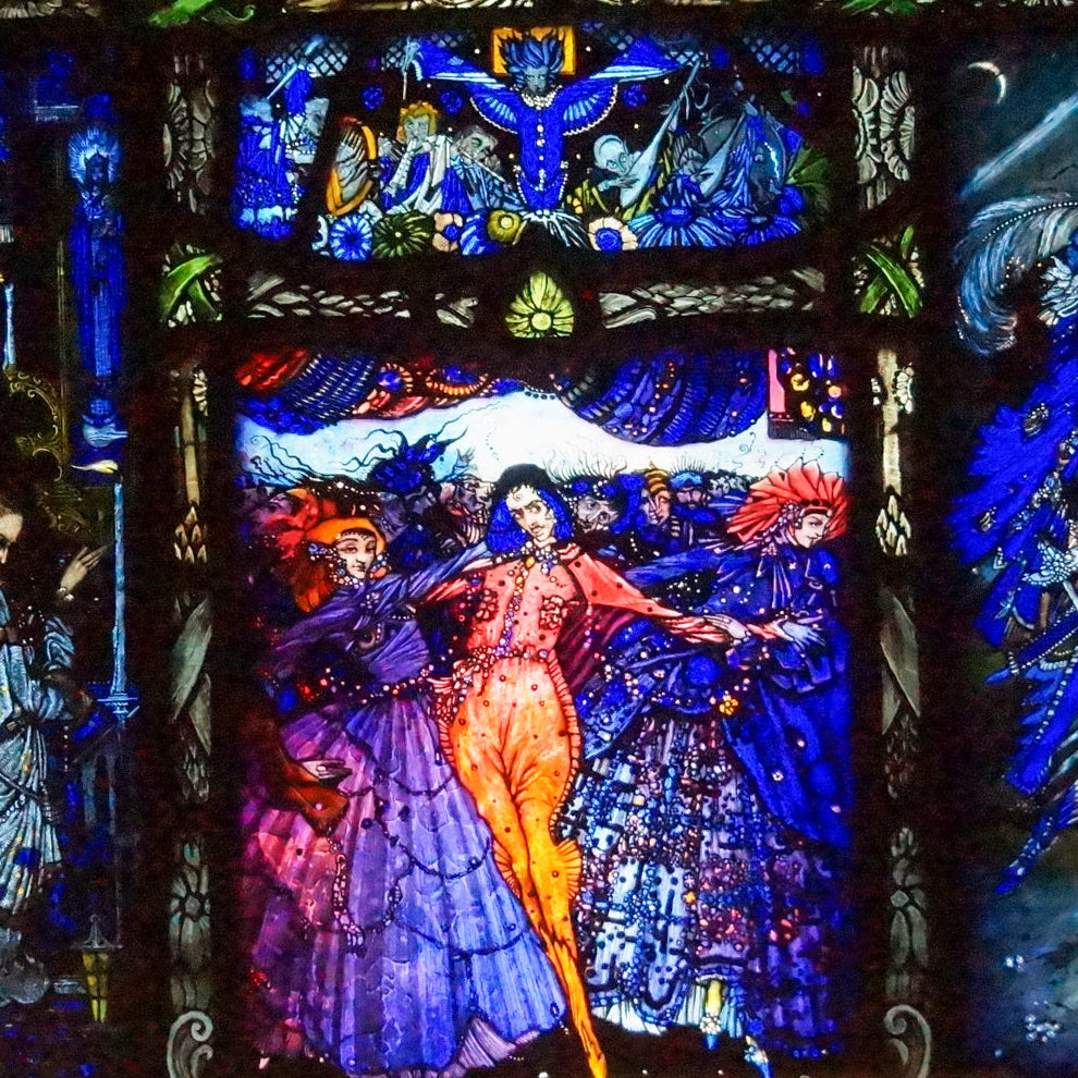Stained glass window with colorful figures and intricate designs