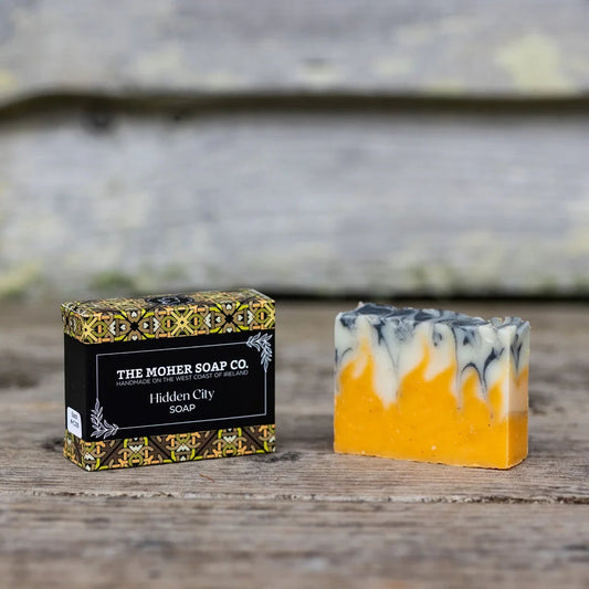 Bar of soap with a decorative box on a wooden surface
