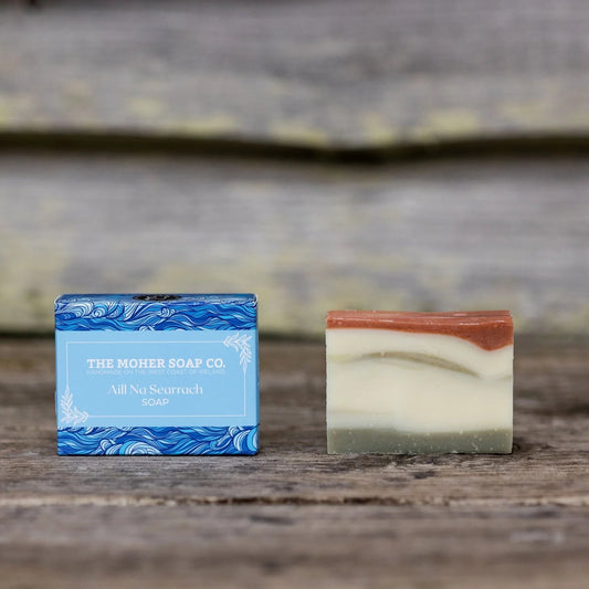 Two soap bars from The Moher Soap Co on a wooden surface