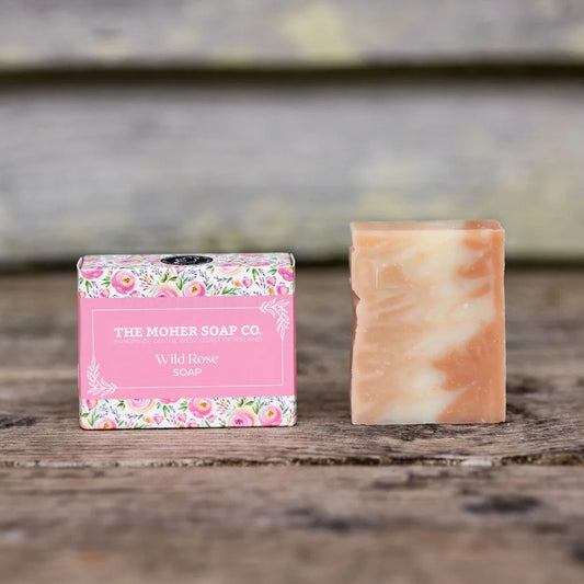 Bar of soap with a floral packaging label on a wooden surface