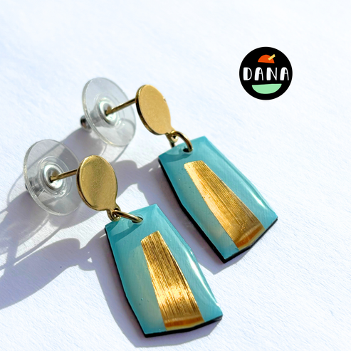Turquoise and gold earrings with 'Dana' branding on a white background