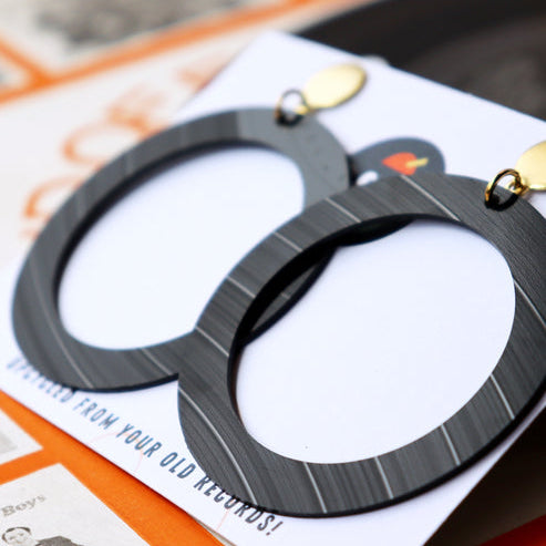 Black metal bottle opener on a card with text
